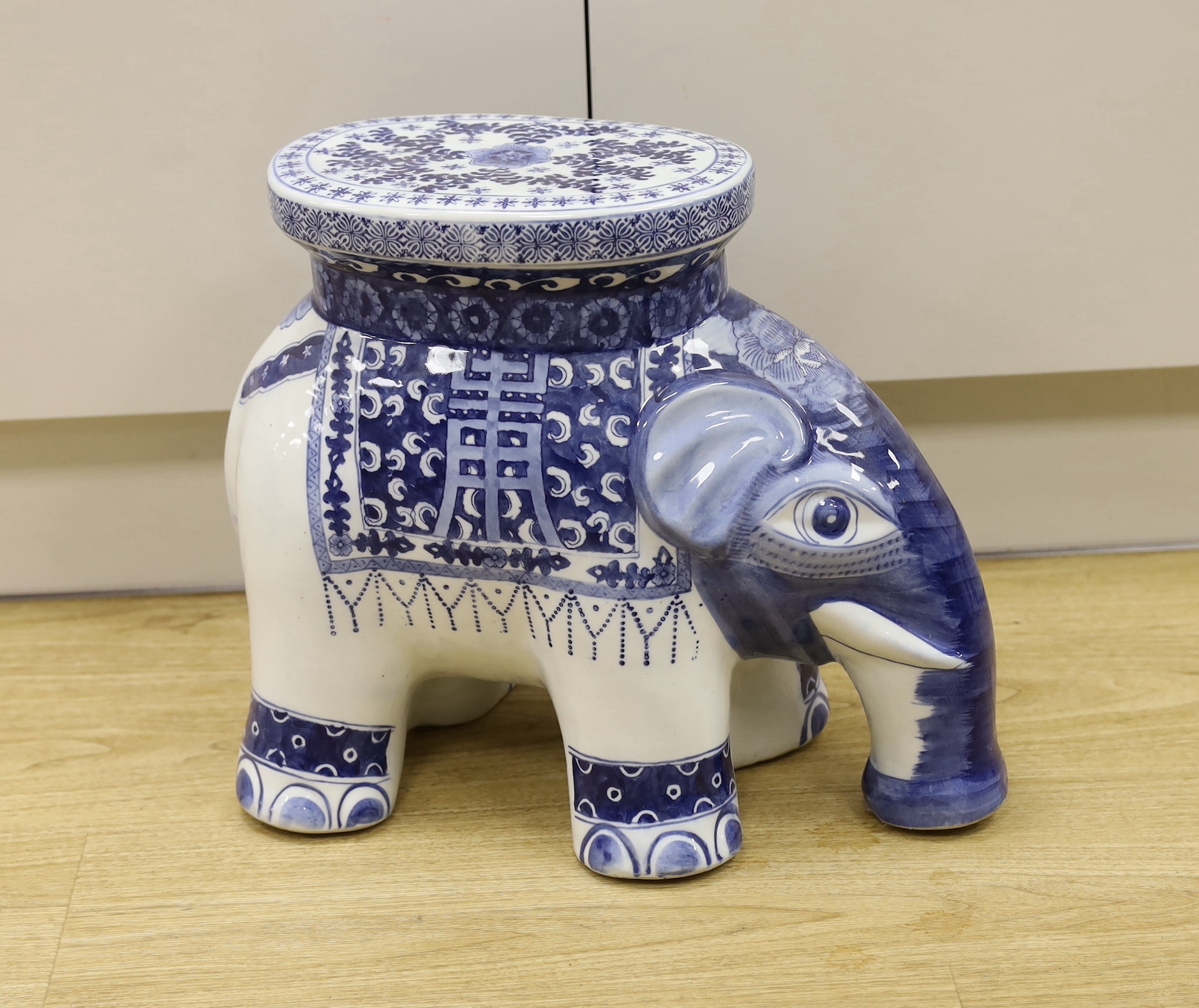 A porcelain conservatory seat in the form of an elephant in a Chinese style, 37cm high